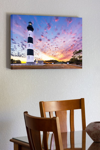 Bodie Island Lighthouse at Sunset: A Beacon Beneath Cotton Candy Skies. This stunning scene captures the magic of the Outer Banks, where history and nature blend seamlessly.
Interesting Facts About Bodie Island Lighthouse:
	1.	Third Time’s the Charm: The current Bodie Island Lighthouse is the third built on this site. The first one was abandoned due to structural issues, and the second was destroyed during the Civil War.
	2.	Height and Reach: Standing at 156 feet, the lighthouse’s first-order Fresnel lens