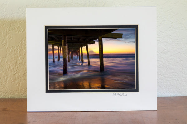 Long exposure under the Nags Head Fishing Pier just before sunrise. Nags Head Pier is one of the oldest and longest piers on the Outer Banks.It is one of the few Outer Banks piers to have a restrant.