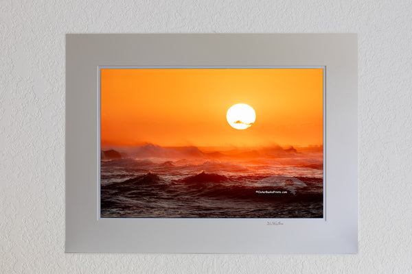 Sunset from Cape Point on Cape Hatteras Island looking towards Hatteras Village across a firey windsweept sea.