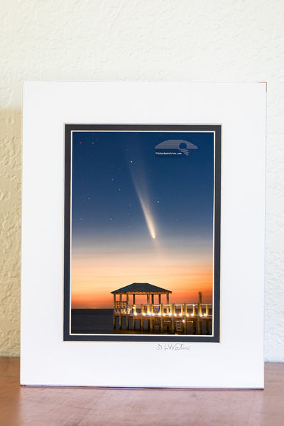 The comet known as C/2023 A3 Tsuchinshan-ATLAS, shines over Kitty Hawk Bay at twilight, captured from Kill Devil Hills beach boat ramp. The gazebo and dock in the foreground add a peaceful touch to this Outer Banks view.