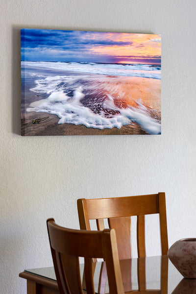 Sunrise long exposure of surf and seafoam in Corolla, on the Outer Banks of NC.