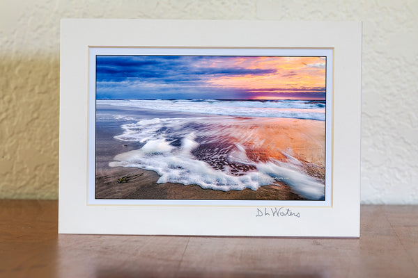 Sunrise long exposure of surf and seafoam in Corolla, on the Outer Banks of NC.