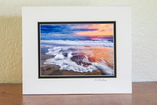 Sunrise long exposure of surf and seafoam in Corolla, on the Outer Banks of NC.