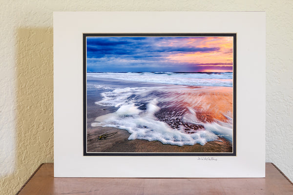 Sunrise long exposure of surf and seafoam in Corolla, on the Outer Banks of NC.