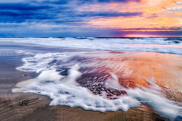 Sunrise long exposure of surf and seafoam in Corolla, on the Outer Banks of NC.