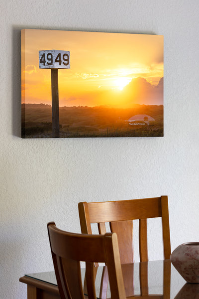 Backlit by the warm glow of the setting sun, the Ramp 49 sign stands against a backdrop of rolling dunes and golden light. A favorite fishing access on Hatteras Island, this spot is a go-to for locals and visitors drawn to the quiet beauty of the area.