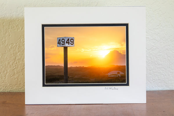 Backlit by the warm glow of the setting sun, the Ramp 49 sign stands against a backdrop of rolling dunes and golden light. A favorite fishing access on Hatteras Island, this spot is a go-to for locals and visitors drawn to the quiet beauty of the area.