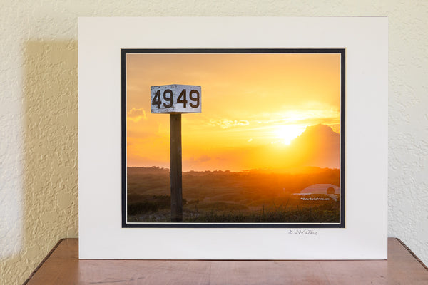 Backlit by the warm glow of the setting sun, the Ramp 49 sign stands against a backdrop of rolling dunes and golden light. A favorite fishing access on Hatteras Island, this spot is a go-to for locals and visitors drawn to the quiet beauty of the area.