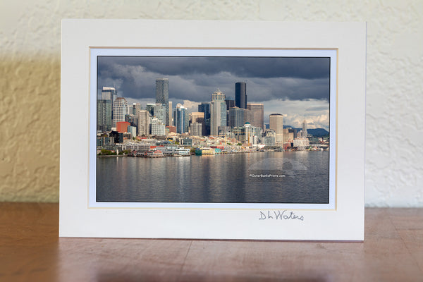 Seattle skyline on a stormy afternoon. The light had just broken through the clouds, making the skyline stand out from the dark clouds.