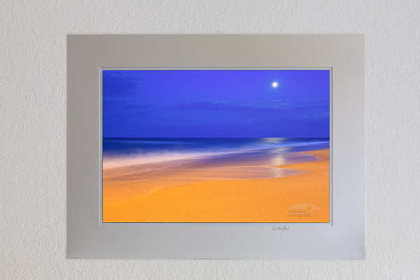 13 x 19 luster print in 18 x 24 ivory mat of These colors are pretty much how I saw  them.  The yellow on the beach is from an incandescent spotlight shining from Kitty Hawk pier. The blue in the sky is the natural twilight color. I had to use a long exposure to gather enough light. The waves became very soft as they moved during the exposure.