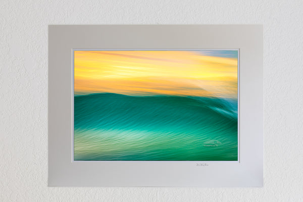 13 x 19 luster print in 18 x 24 ivory mat of Impression of a wave at sunrise, using a long exposure to show movement on the outer Banks of NC.