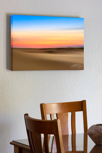 20"x30" x1.5" stretched canvas print hanging in the dining room of An impression of Jockey's Ridge State Park at sunset. Moving the camera while the shutter is open creates impressionistic photographs.