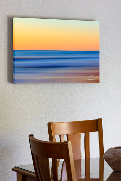 20"x30" x1.5" stretched canvas print hanging in the dining room of A Outer Banks beach sunrise reduced to colors and lines. Using camera movement during a long exposure to blur the beach and ocean.