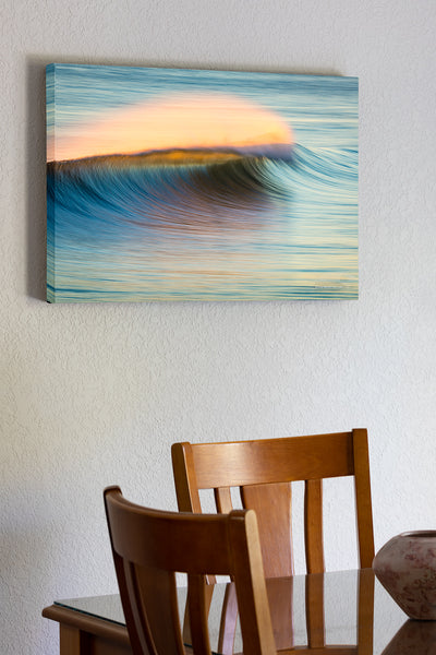 20"x30" x1.5" stretched canvas print hanging in the dining room of Sunrise windblown surf spray at Kitty Hawk Pier photographed with a long telephoto lens and a slow shutter speed.