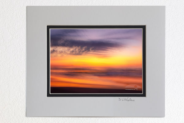5 x 7 luster prints in a 8 x 10 ivory and black double mat of This sunrise beach impression was captured bouncing along wile driving on the beach using a 1/4 second shutter speed. in Corolla on the Outer Banks of North Carolina.