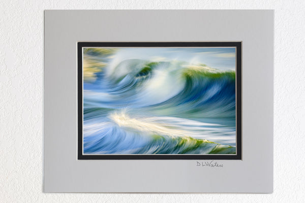 8x10 luster print in 11x14 outer ivory  inner black mat of a wild horse silhouette on the beach in front of surf at sunrise in Corolla, NC on the Outer Banks.