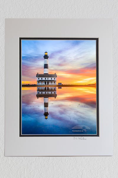 8 x 10 luster print in a 11 x 14 ivory and black double mat of Reflection of sunrise and Bodie Island Lighthouse after a hard rain.