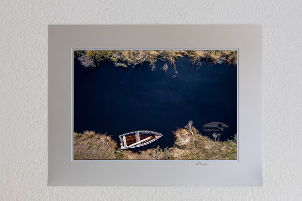 Aerial photo of a wooden skiff on a creek off the Albemarle Sound in Alligator River Wildlife Refuge.