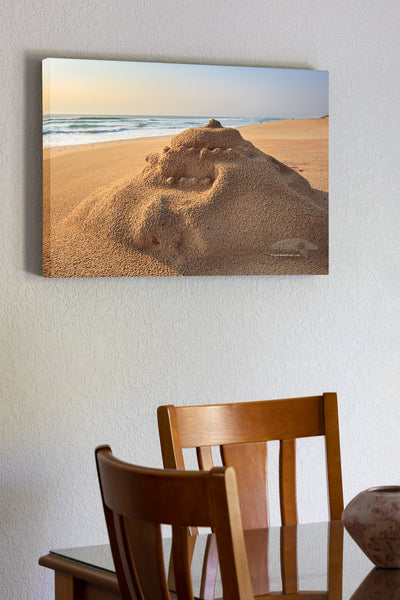 20"x30" x1.5" stretched canvas print hanging in the dining room of Sunrise sand castle after a rain storm at a Outer Banks beach.