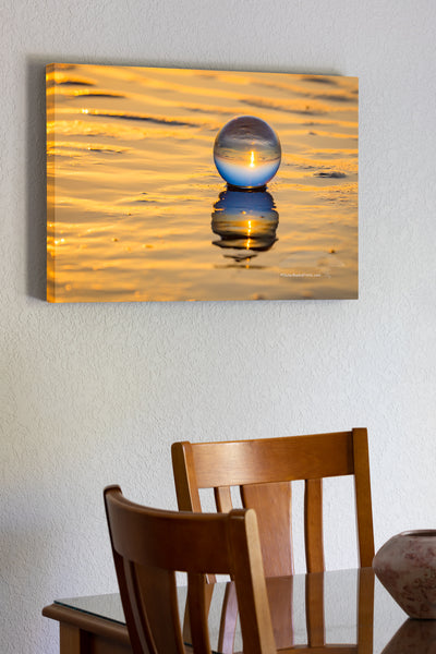 Crystal ball and it's reflection at sunrise on the beach at the Outer Banks , NC.