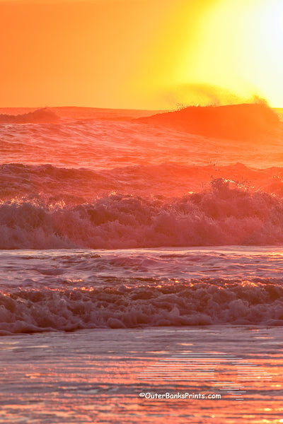 Warm orange sunrise surf at a Outer Banks beach.