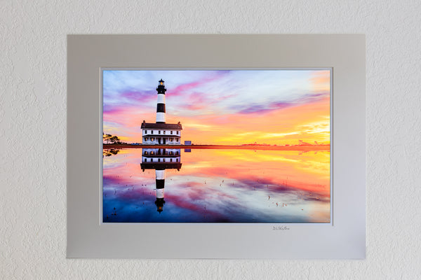 13 x 19 luster print in 18 x 24 ivory mat of Reflection of sunrise and Bodie Island Lighthouse after a hard rain.