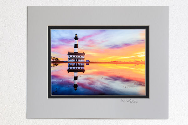 5 x 7 luster prints in a 8 x 10 ivory and black double mat of Reflection of sunrise and Bodie Island Lighthouse after a hard rain.