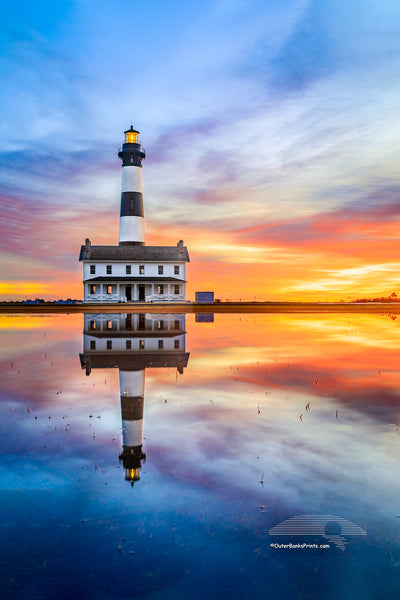 Reflection of sunrise and Bodie Island Lighthouse after a hard rain.