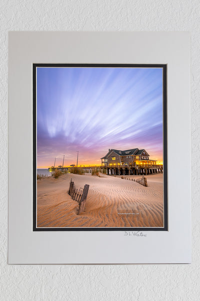 8 x 10 luster print in a 11 x 14 ivory and black double mat of Cloud streaks in the sky, a result of two minute exposure time, above Jennette's pier Nags Head on the Outer Banks of North Carolina.