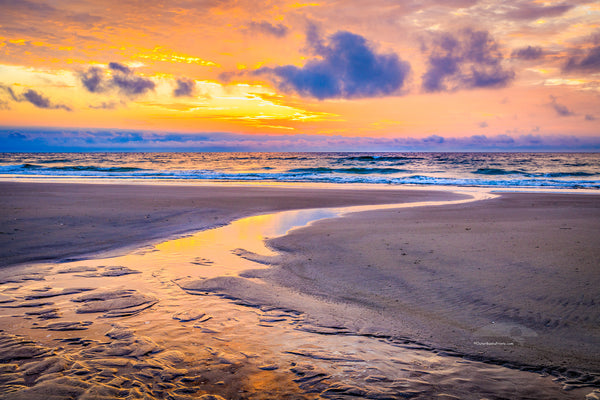 Tidepool emptying into the Atlantic Ocean at sunrise in Corolla on the Outer Banks of NC.