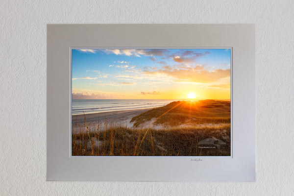 Sun setting over sanddunes along the Frisco costline in Cape Hatteras National Seashore, NC.