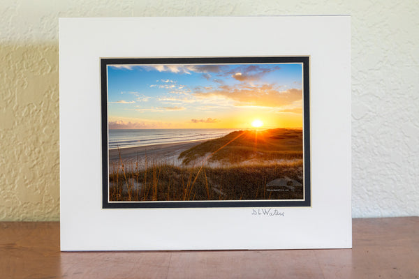 Sun setting over sanddunes along the Frisco costline in Cape Hatteras National Seashore, NC.