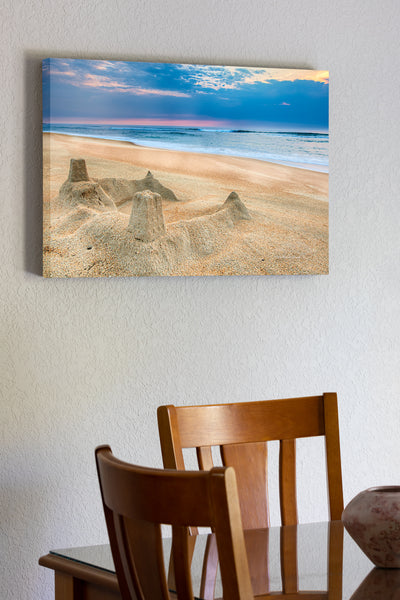 20"x30" x1.5" stretched canvas print hanging in the dining room of The sun rising behind a sandcastle on the beach at Kill Devil Hills on the Outer Banks of North Carolina.