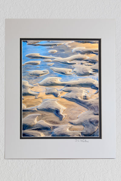 8 x 10 luster print in a 11 x 14 ivory and black double mat of A close-up of sand and water pattern at Oregon Inlet North Carolina.