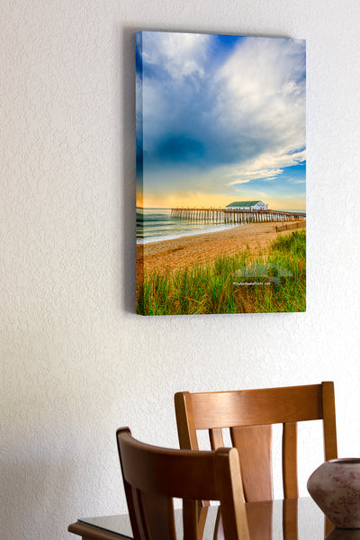 20"x30" x1.5" stretched canvas print hanging in the dining room of Kitty Hawk fishing pier morning light after a storm on the Outer Banks.  Edit alt text