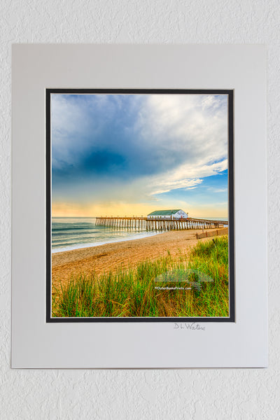 8 x 10 luster print in a 11 x 14 ivory and black double mat of Kitty Hawk fishing pier morning light after a storm on the Outer Banks.  Edit alt text