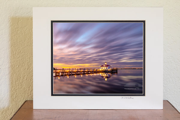 This two minute long exposure before sunrise shows the clouds moving past Roanoke Marshes Lighthouse in Manteo on the Outer Banks of North Carolina. This  lighthouse is a replica of a river lighthouse that was located at in the sound in Wanchese