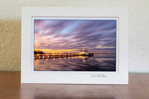 This two minute long exposure before sunrise shows the clouds moving past Roanoke Marshes Lighthouse in Manteo on the Outer Banks of North Carolina. This  lighthouse is a replica of a river lighthouse that was located at in the sound in Wanchese