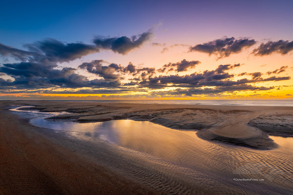 This is in Buxton North Carolina on the beach next to the Cape Hatteras Lighthouse. I love photographing the beach because every time you go you have a new landscape to photograph
