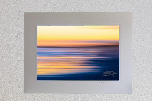 Intentional camera movement to create long streaks of light at sunset along Frisco beach in Cape Hatteras National Seashore, NC.