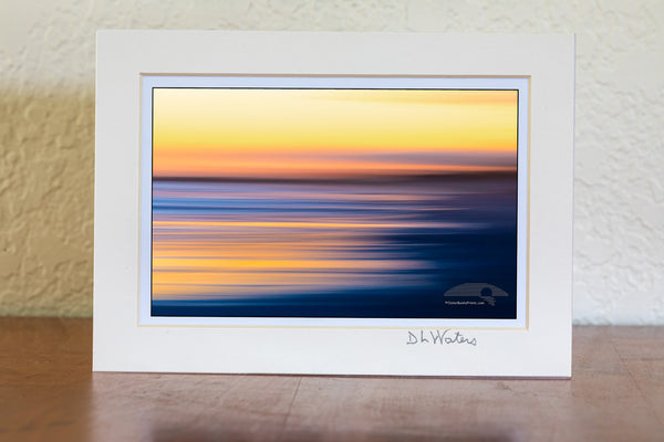 Intentional camera movement to create long streaks of light at sunset along Frisco beach in Cape Hatteras National Seashore, NC.