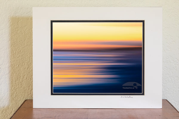 Intentional camera movement to create long streaks of light at sunset along Frisco beach in Cape Hatteras National Seashore, NC.