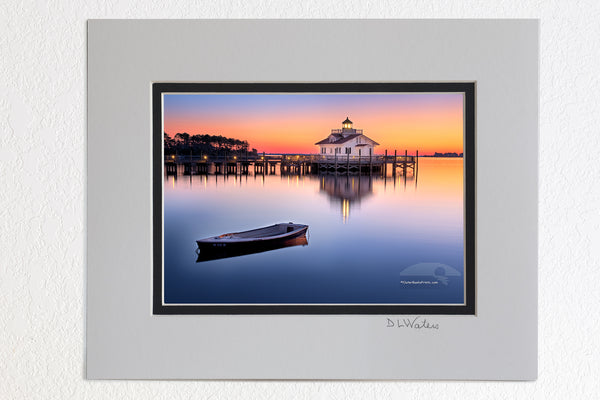 8 x 10 luster print in a 11 x 14 ivory and black double mat of Roanoke Marshes Lighthouse On the waterfront of Manteo,NC, the Roanoke Marshes Light is a reconstruction of the square cottage-style screw-pile lighthouse which stood at the southern entrance to Croatan Sound, near Wanchese.