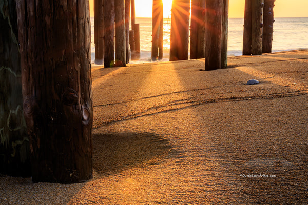 Under the Kitty Hawk Fishing Pier at sunrise on the Outer Banks of NC.