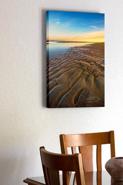 Ripples of sand become visible as the tide receds at Oregon Inlet in the Cape Hatteras National Seashore on the Outer Banks of North Carolina.