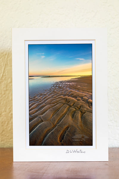 Ripples of sand become visible as the tide receds at Oregon Inlet in the Cape Hatteras National Seashore on the Outer Banks of North Carolina.