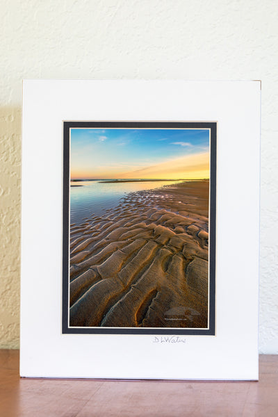 Ripples of sand become visible as the tide receds at Oregon Inlet in the Cape Hatteras National Seashore on the Outer Banks of North Carolina.
