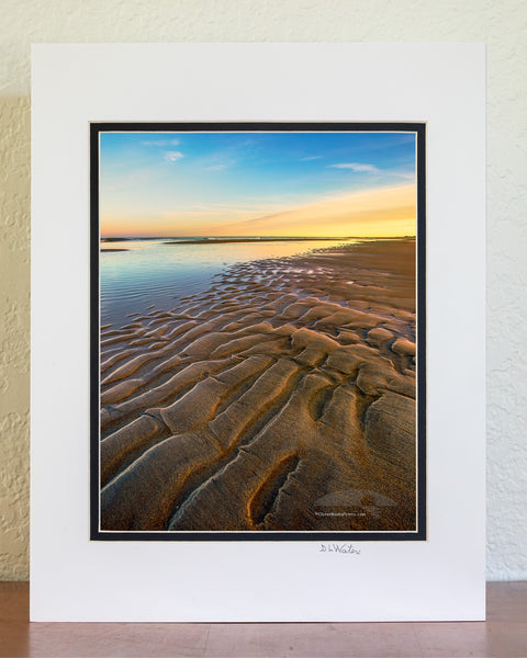 Ripples of sand become visible as the tide receds at Oregon Inlet in the Cape Hatteras National Seashore on the Outer Banks of North Carolina.
