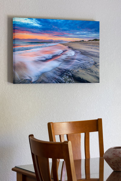20"x30" x1.5" stretched canvas print hanging in the dining room of Colorful sunrise over surf at Coquina Beach in Cape Hatteras National Seashore on the Outer Banks of NC.