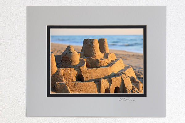 5 x 7 luster prints in a 8 x 10 ivory and black double mat of Elaborate sand castle at sunrise on a Outer Banks beach.